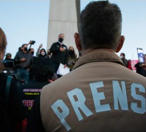 Man in vest "Prensa" on his back watching the demonstration for crimes against journalists in Mexico