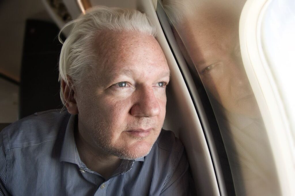 Julian Assange no avião em que deixou o Reino Unido