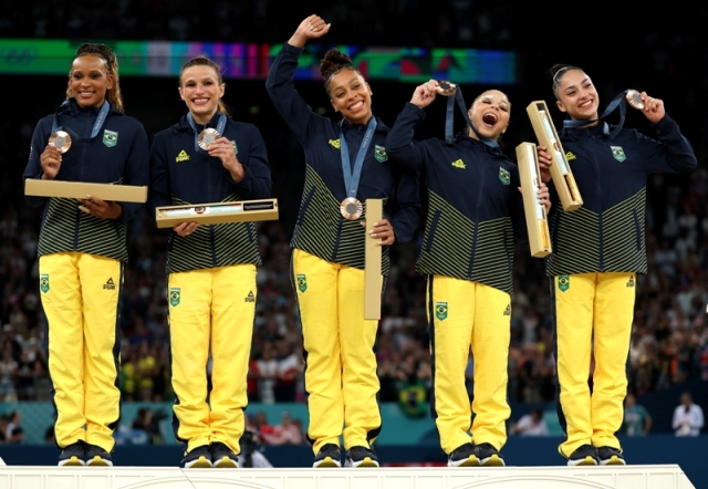 Equipe da ginástica artística no pódio ao receber a medalha de bronze nas Olimpíadas de Paris