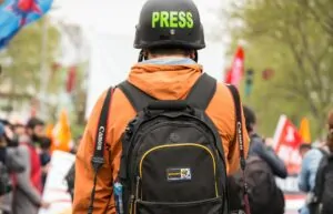 Profissional de imprensa com capacete Press